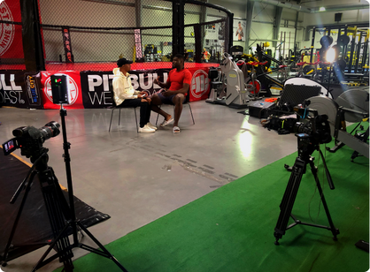 Behind the scenes of 'Africans In Sports' interview setup in a gym.